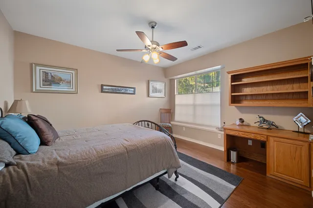 a bedroom with a bed and a desk