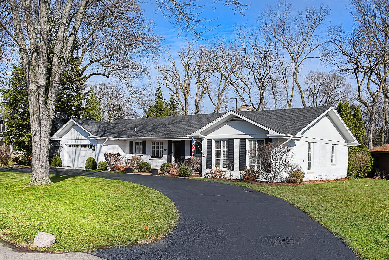 2005 Valley View Road Northfield, IL 60093 - Photo 2 of 8 a front view of a house with a garden and trees