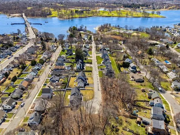 an aerial view of residential houses with outdoor space and swimming pool
