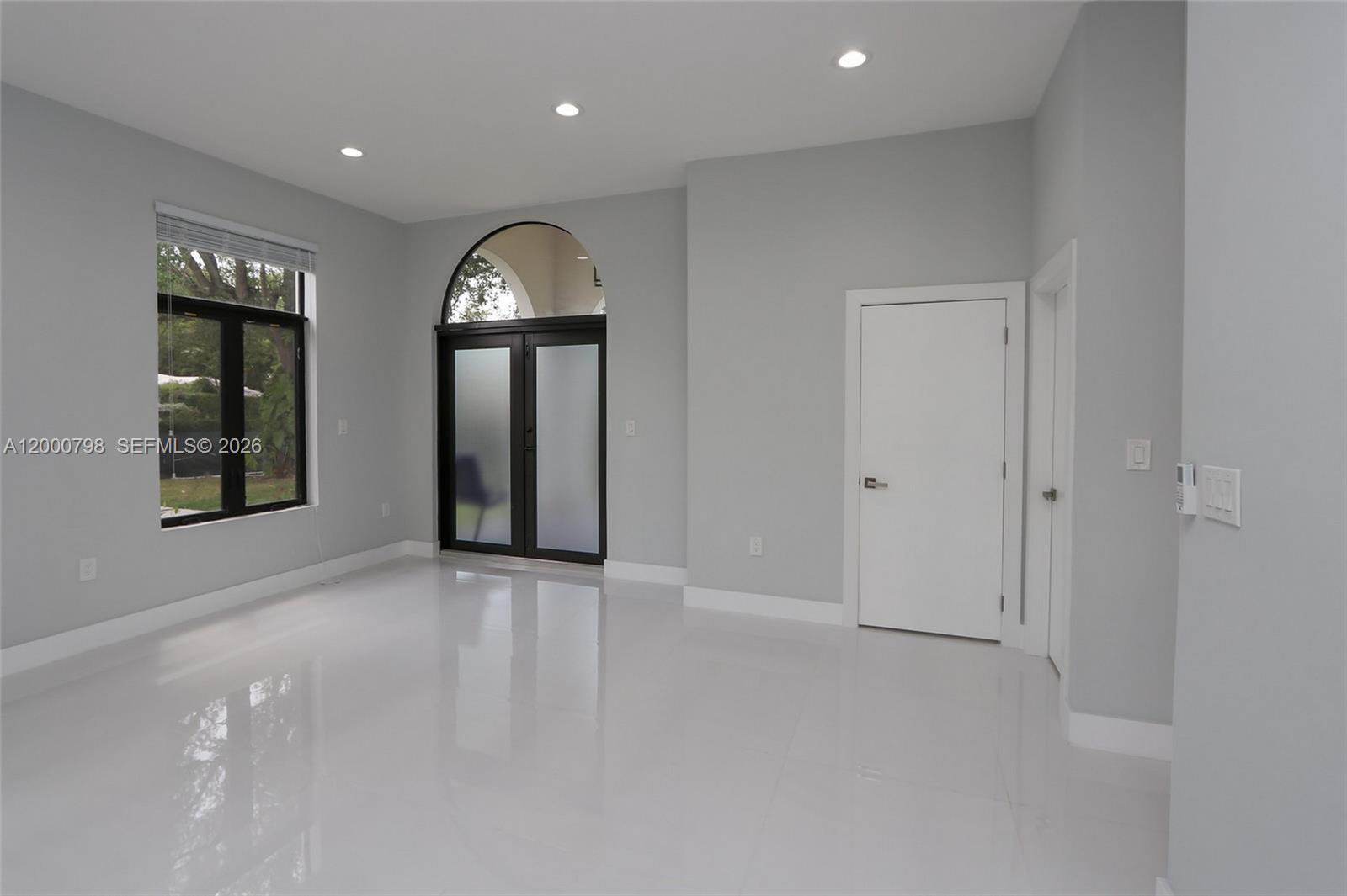 5126 Southwest 57th Avenue Miami, FL 33155 - Photo 11 of 32 an empty room with mirror and a window