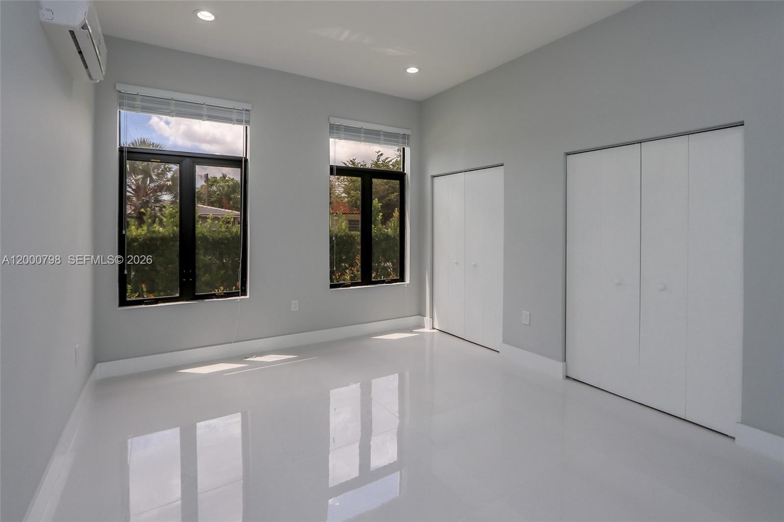 5126 Southwest 57th Avenue Miami, FL 33155 - Photo 17 of 32 a view of an empty room with two windows and chandelier