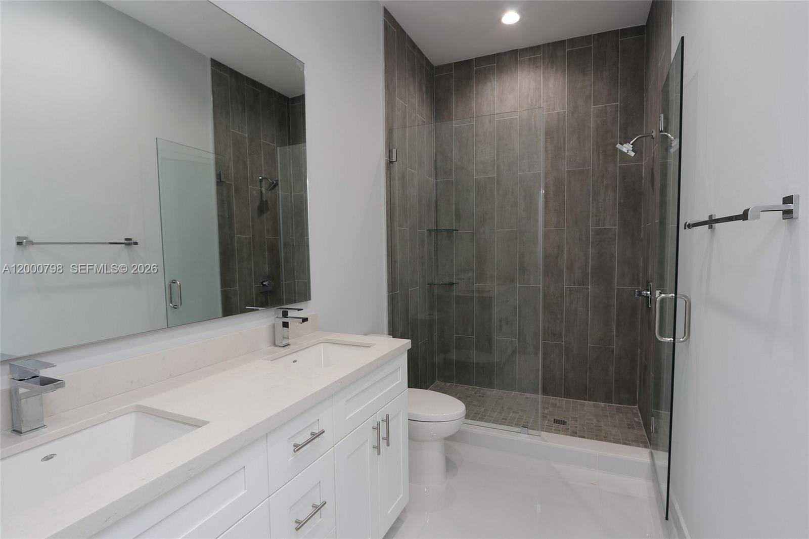 5126 Southwest 57th Avenue Miami, FL 33155 - Photo 18 of 32 a bathroom with a sink a toilet and shower