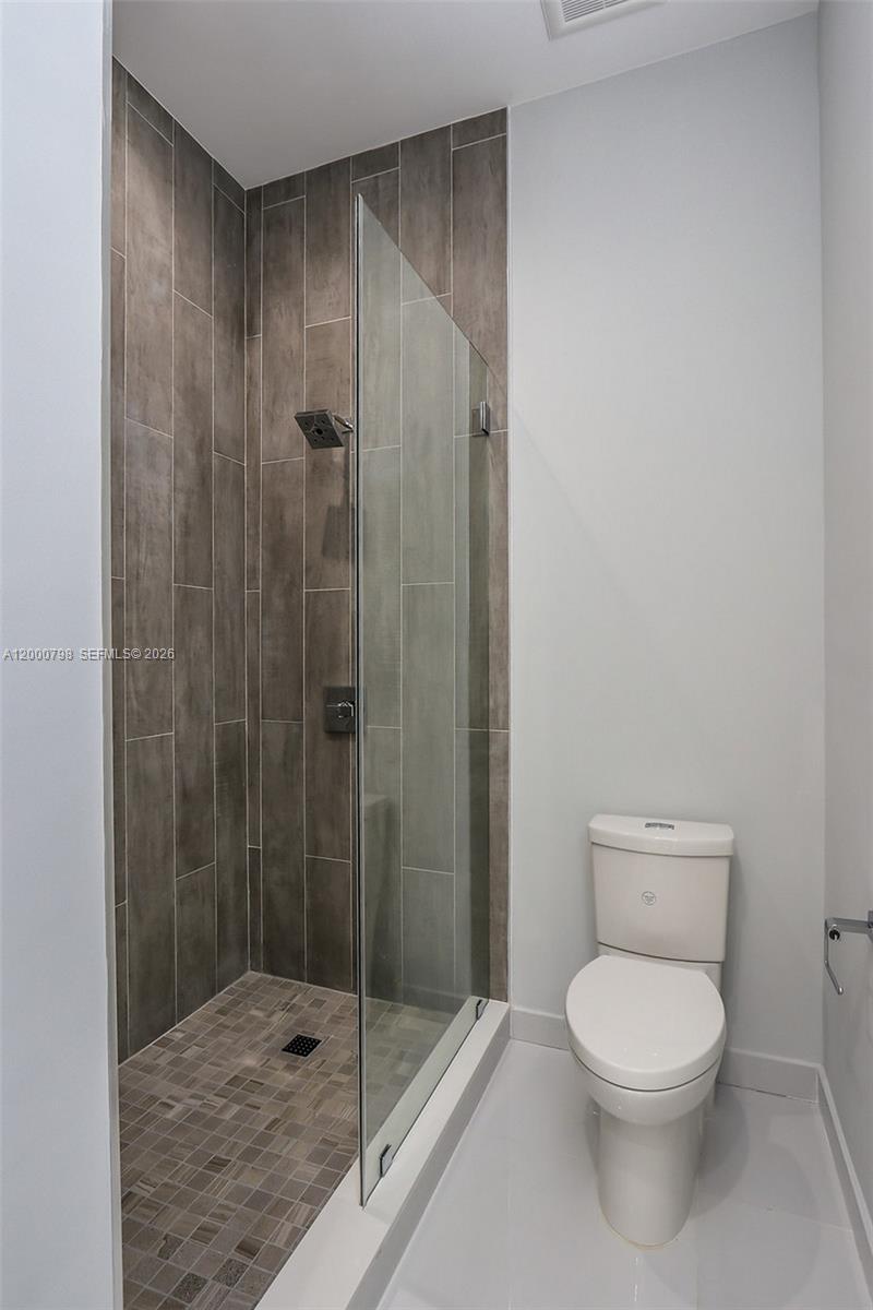 5126 Southwest 57th Avenue Miami, FL 33155 - Photo 21 of 32 a bathroom with a toilet and a shower