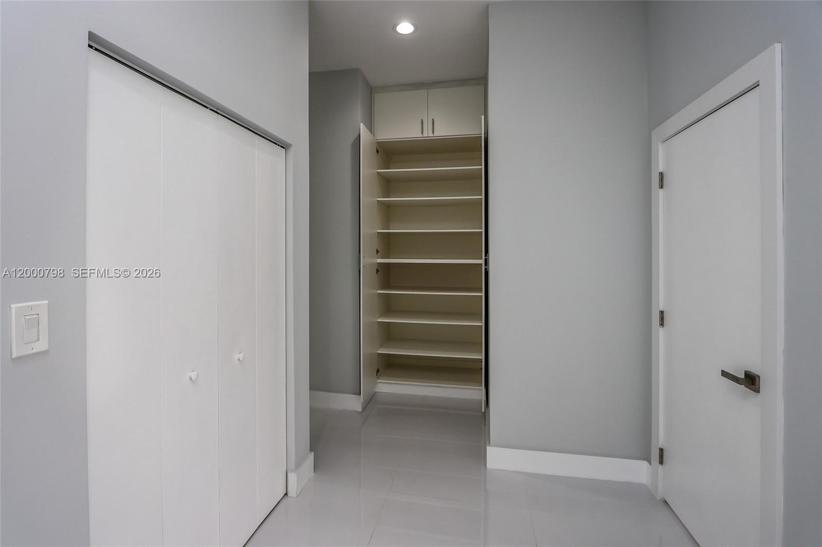 5126 Southwest 57th Avenue Miami, FL 33155 - Photo 22 of 32 a view of walk in closet with empty racks