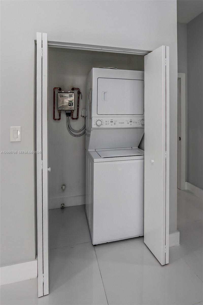 5126 Southwest 57th Avenue Miami, FL 33155 - Photo 23 of 32 a utility room with dryer and washer
