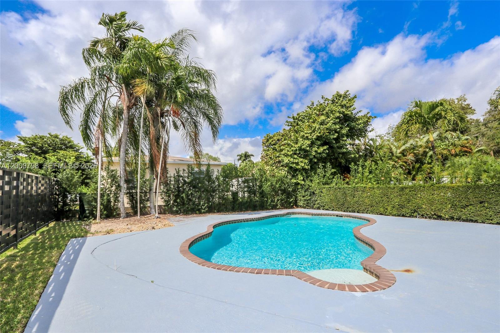5126 Southwest 57th Avenue Miami, FL 33155 - Photo 26 of 32 a view of a swimming pool and a yard