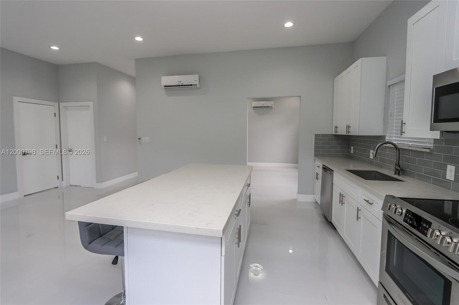 5126 Southwest 57th Avenue Miami, FL 33155 - Photo 6 of 32 a kitchen with a sink stove and cabinets