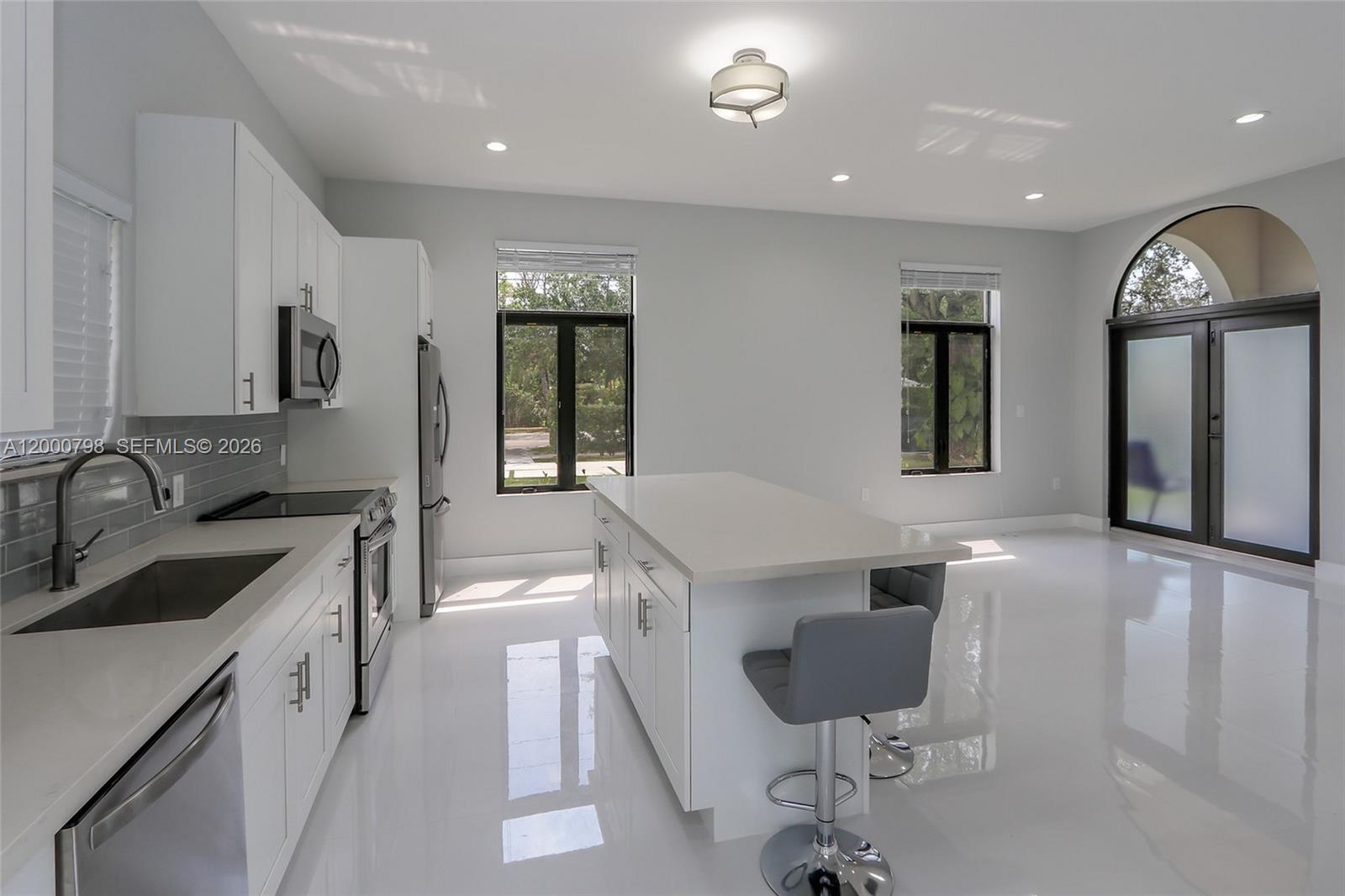 5126 Southwest 57th Avenue Miami, FL 33155 - Photo 8 of 32 a kitchen with a sink cabinets and window