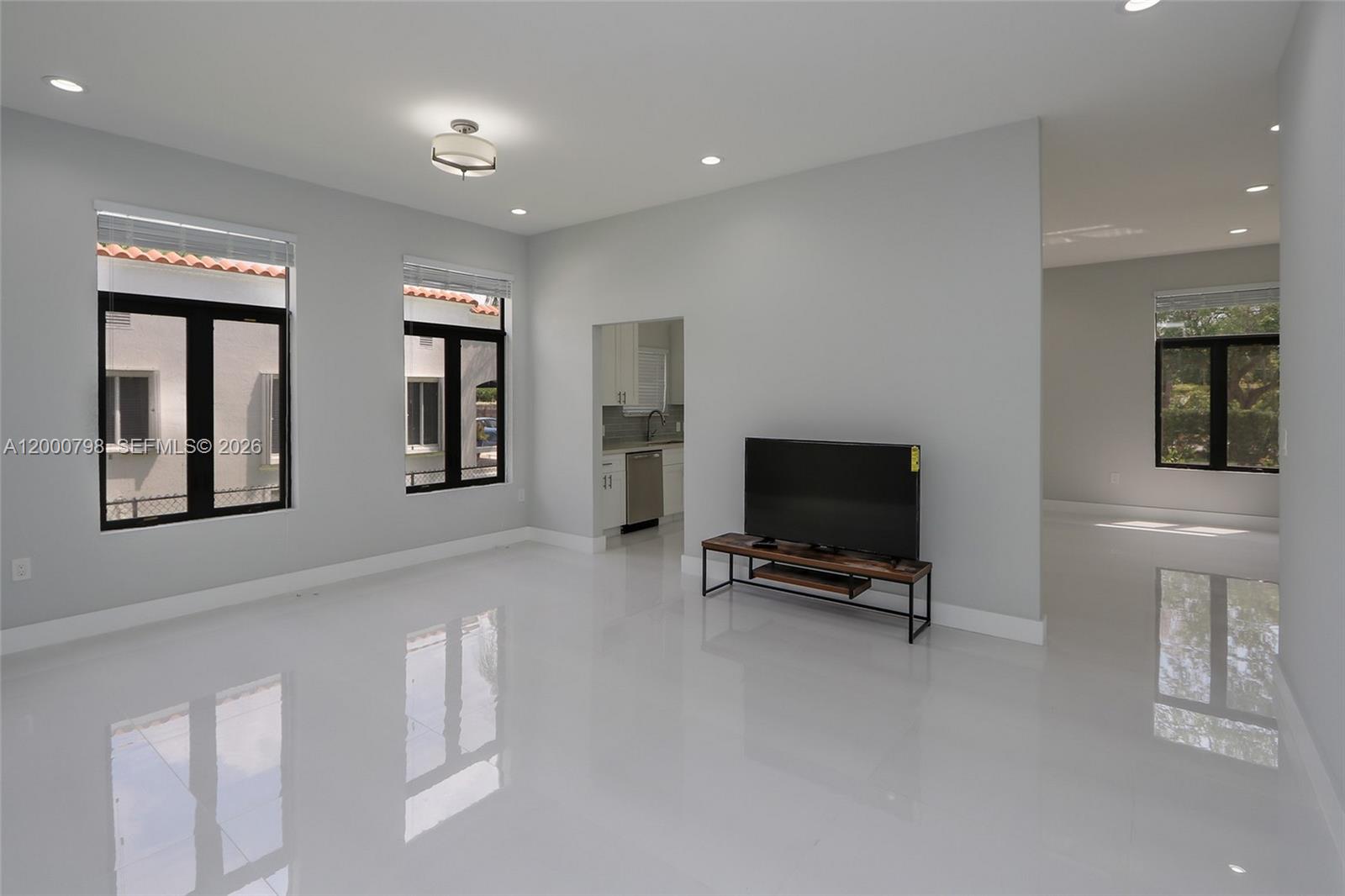 5126 Southwest 57th Avenue Miami, FL 33155 - Photo 10 of 32 a living room with furniture and a flat screen tv