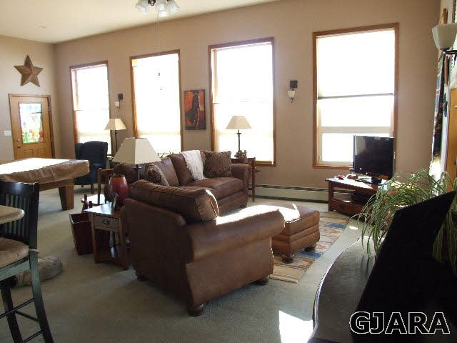 1074 24 Road Grand Junction, CO 81505 - Photo 8 of 37 a living room with furniture and a large window