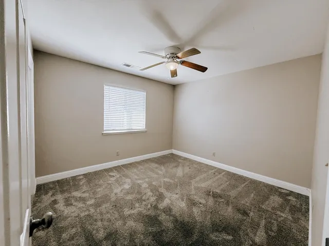 a view of room with window and ceiling fan
