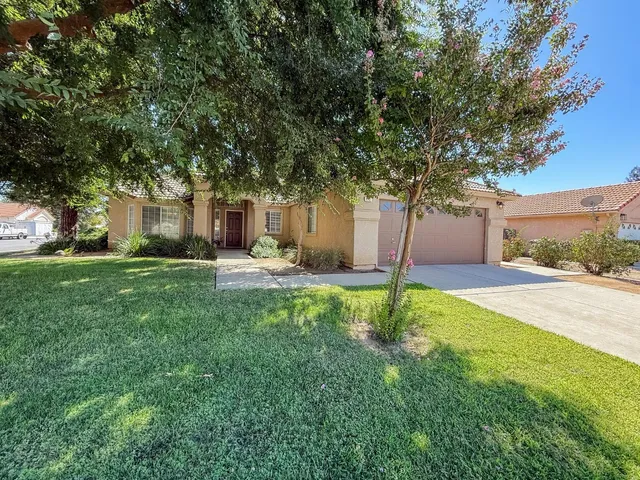 a house that has a tree in front of it