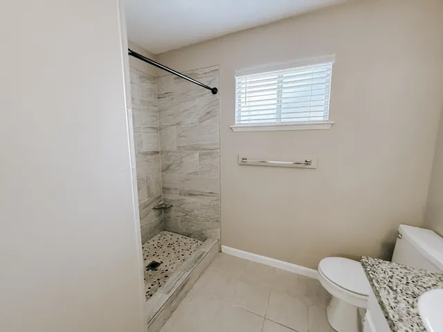 a bathroom with a toilet and shower