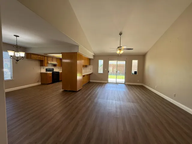 a view of a room with wooden floor kitchen view