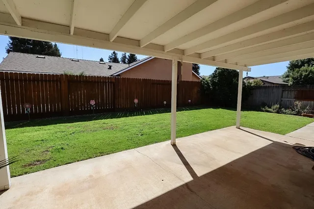 a view of a patio with a yard