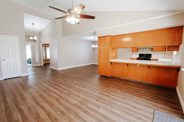 a view of a kitchen with a sink and wooden floor