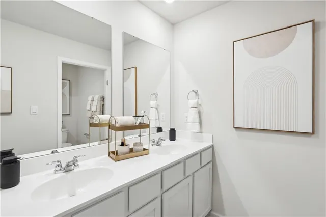 a bathroom with 2 sink and a mirror