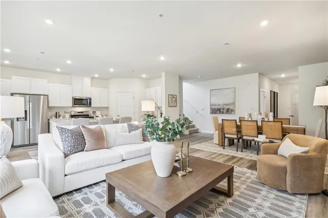 a living room with furniture kitchen and a table