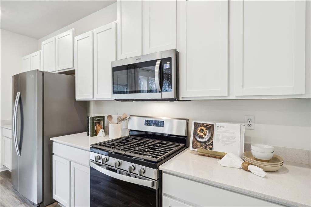 3403 Maple Crest Court Butler, PA 16001 - Photo 10 of 48 a kitchen with granite countertop a stove and a white cabinet