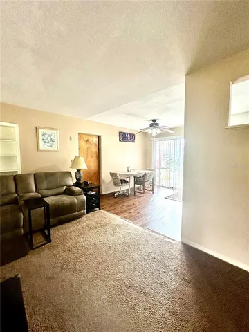 a living room with furniture and a floor to ceiling window