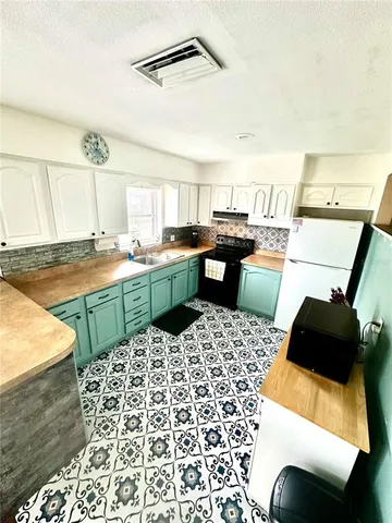 a kitchen with a sink and a stove top oven