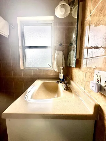 a bathroom with a sink and a large mirror