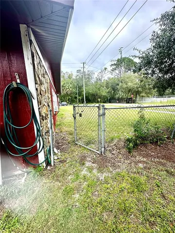 a backyard of a house with garden table and chairs