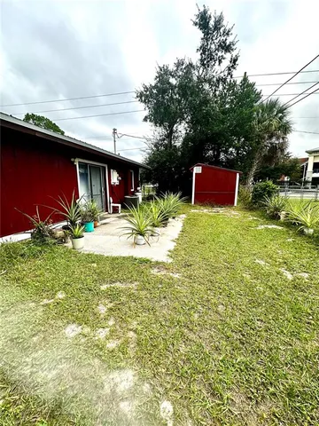 a view of backyard with outdoor seating and green space