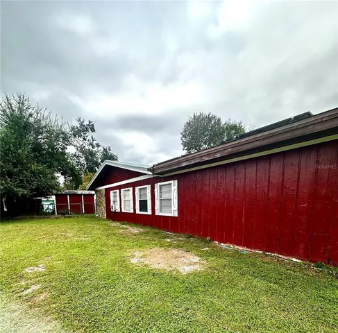 a view of a house with yard and sitting area