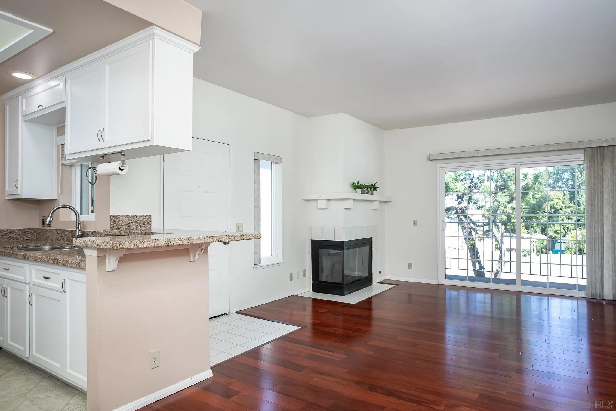13816 Midland Road Poway, CA 92064 - Photo 6 of 37 a kitchen with stainless steel appliances a white stove top oven cabinets and a wooden floor