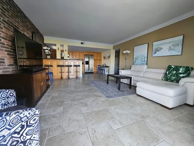a living room with couches and a flat screen tv