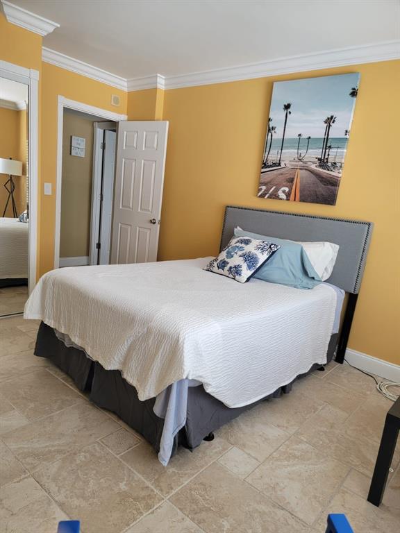 2900 Northeast 30th Street, Unit H3 Fort Lauderdale, FL 33306 - Photo 4 of 11 a bedroom with a bed and wooden floor