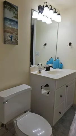 a bathroom with a sink a mirror and a toilet