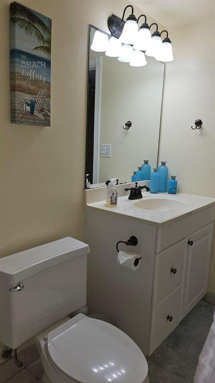 2900 Northeast 30th Street, Unit H3 Fort Lauderdale, FL 33306 - Photo 6 of 11 a bathroom with a sink a mirror and a toilet