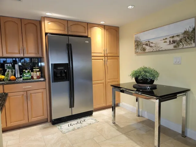 a kitchen with stainless steel appliances a refrigerator and cabinets