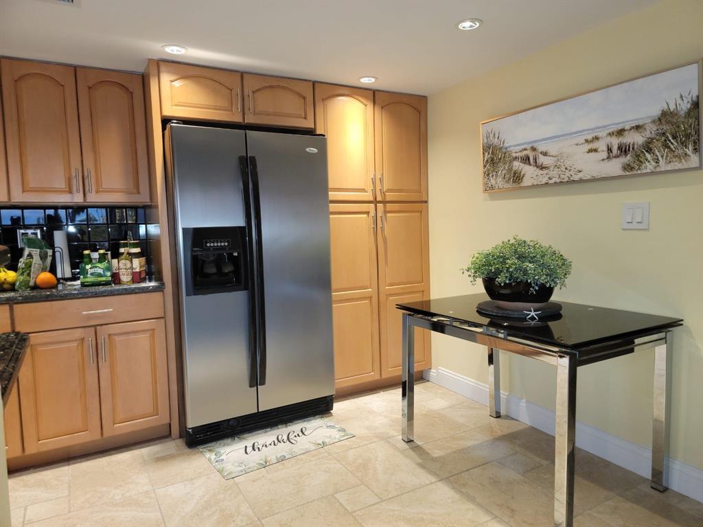 2900 Northeast 30th Street, Unit H3 Fort Lauderdale, FL 33306 - Photo 7 of 11 a kitchen with stainless steel appliances a refrigerator and cabinets