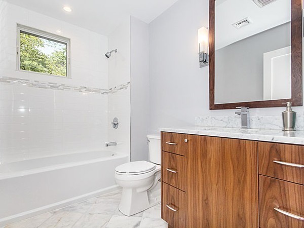24-26 Beaconsfield Road, Unit 26 Brookline, MA 02445 - Photo 12 of 25 a bathroom with a sink a toilet and shower