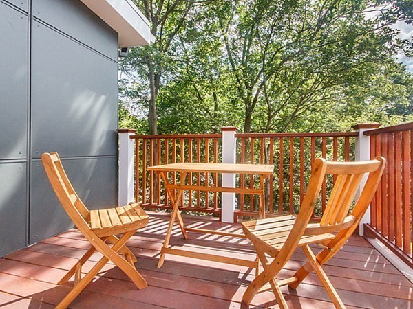 24-26 Beaconsfield Road, Unit 26 Brookline, MA 02445 - Photo 13 of 25 a view of a chairs and table on the patio