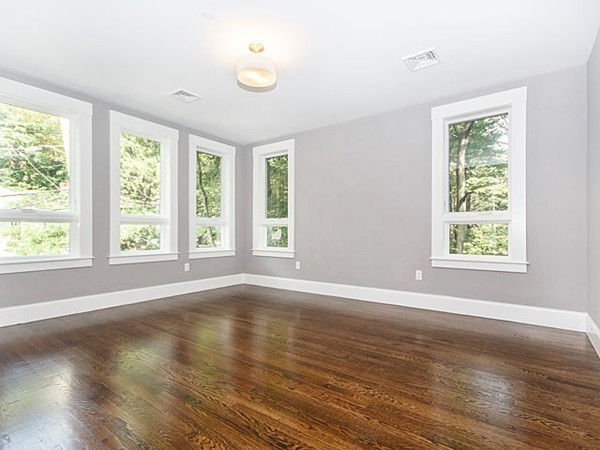 24-26 Beaconsfield Road, Unit 26 Brookline, MA 02445 - Photo 15 of 25 a view of an empty room with wooden floor and a window