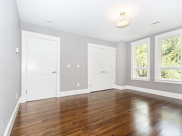 24-26 Beaconsfield Road, Unit 26 Brookline, MA 02445 - Photo 16 of 25 an empty room with wooden floor and windows
