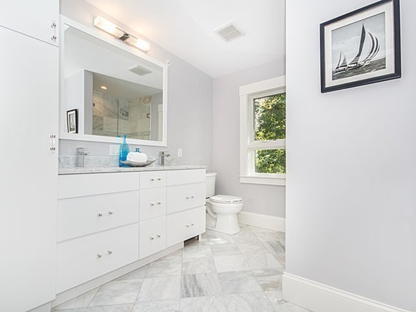 24-26 Beaconsfield Road, Unit 26 Brookline, MA 02445 - Photo 19 of 25 a bathroom with a toilet sink and mirror
