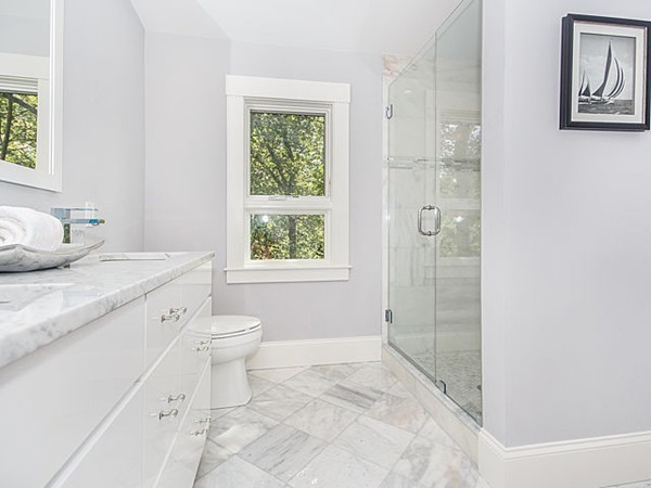 24-26 Beaconsfield Road, Unit 26 Brookline, MA 02445 - Photo 20 of 25 a spacious bathroom with a granite countertop toilet a sink and a mirror