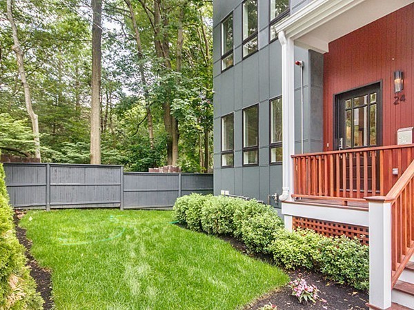 24-26 Beaconsfield Road, Unit 26 Brookline, MA 02445 - Photo 23 of 25 a view of a house with a small yard and wooden fence