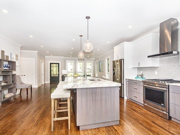 24-26 Beaconsfield Road, Unit 26 Brookline, MA 02445 - Photo 7 of 25 a kitchen with stainless steel appliances kitchen island granite countertop a stove and a refrigerator