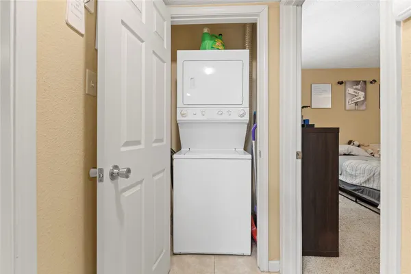 a bedroom with a bed and a flat tv screen on the dresser
