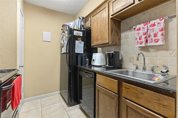 a kitchen that has a sink and a stove