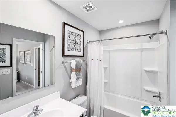 a bathroom with a shower and toilet