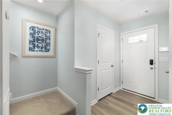 an empty room with wooden floor and window