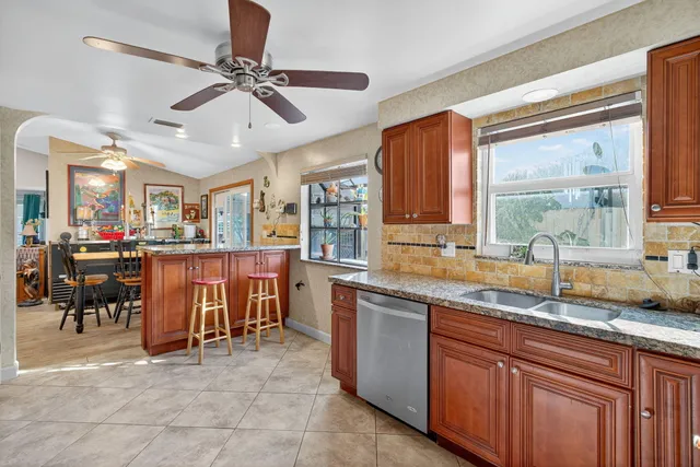 a bathroom with a granite countertop sink mirror vanity and toilet