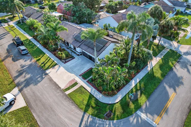 a view of a house with a yard and sitting area